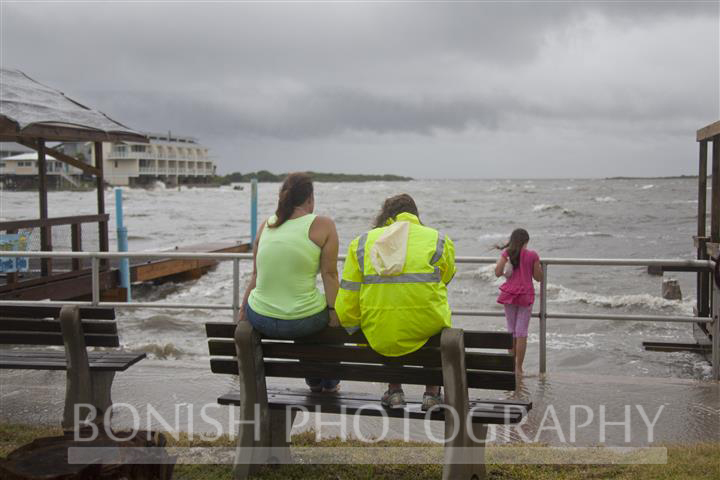 Wendy Slaughter sits on a bench at the Cedar Key Marina as Tropical Storm Andrea makes Landfall - Photo by Pat Bonish